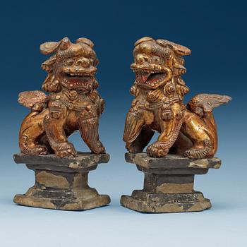 A pair of gilt ceramic figures/censer stick holders, Qing dynasty (1644-1912).