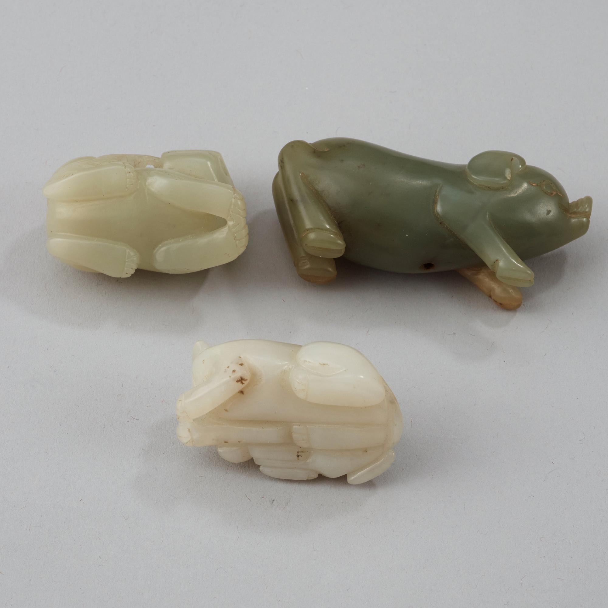 Three Chinese nephrite figure of two buddhist lions and a pig.