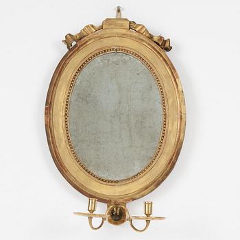 A Gustavian giltwood two-branch girandole mirror, late 18th century.