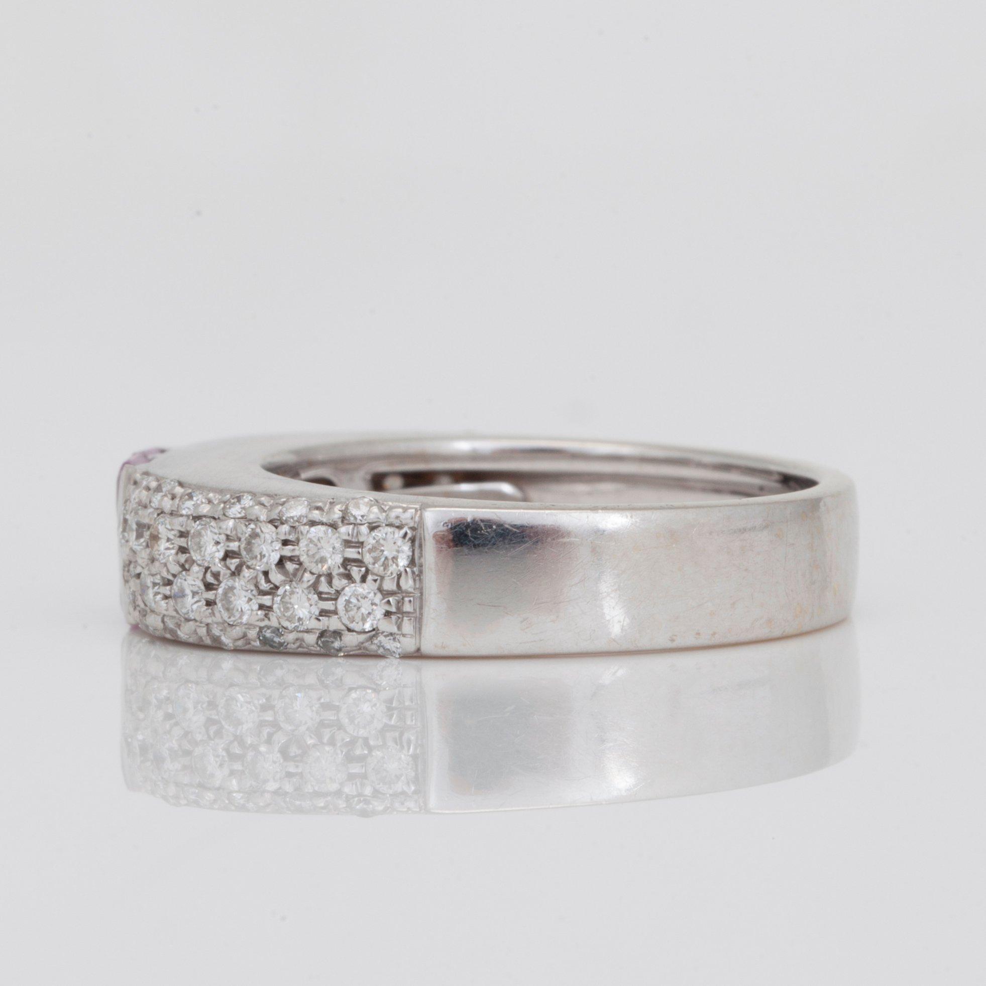 A princess-cut pink sapphire and 0.69ct brilliant-cut diamond ring.
