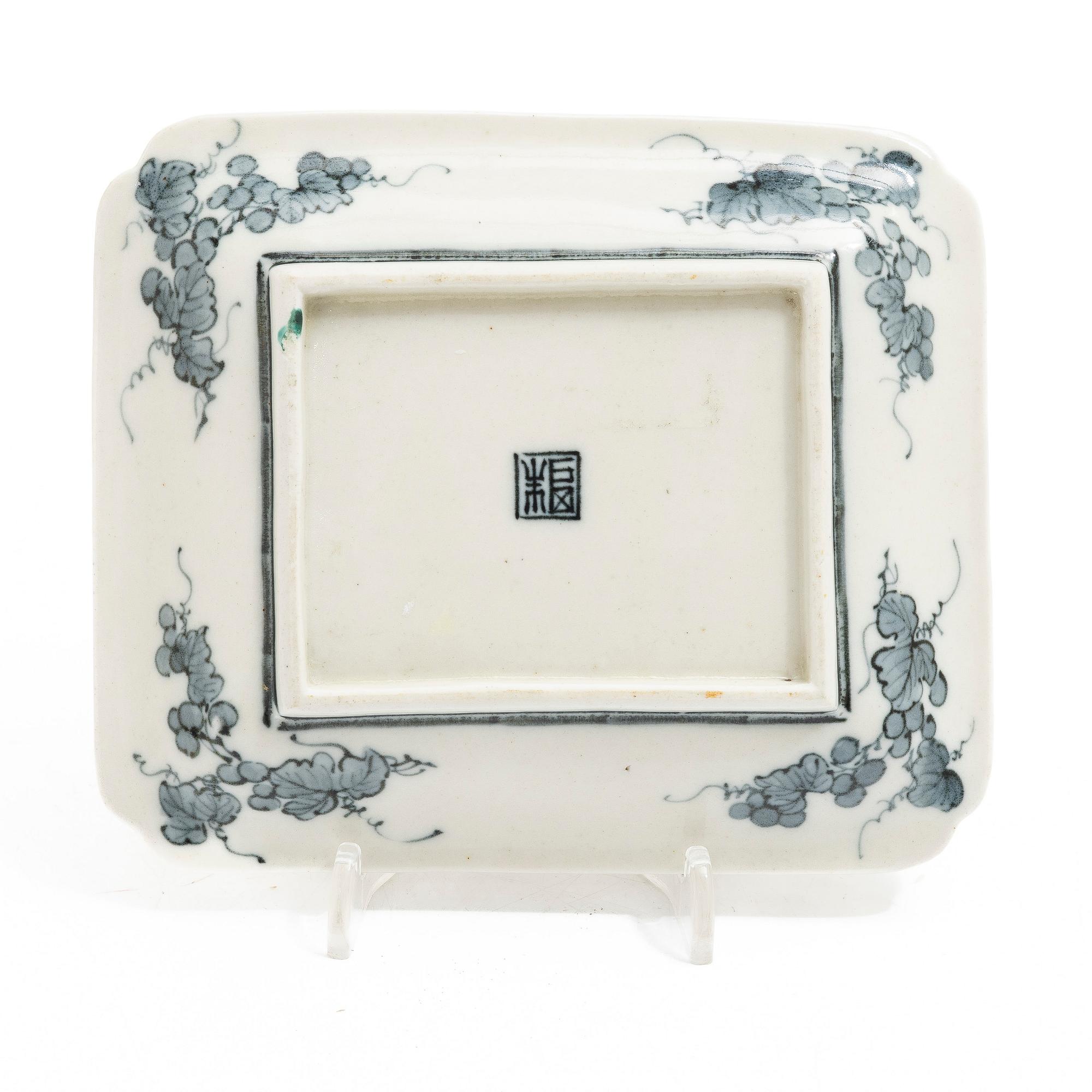 A small Japanese gilt copper box with cover and a porcelain dish, 19th century.