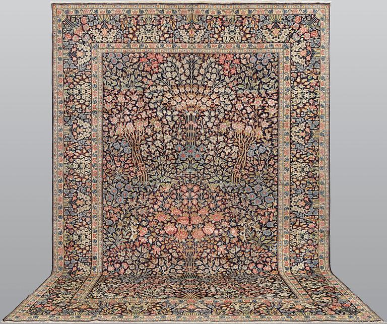 A 'Millefleur' Kerman Laver carpet, c. 410 x 290 cm.