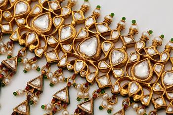 An Indian demi parure comprising a necklace and a pair of earrings.