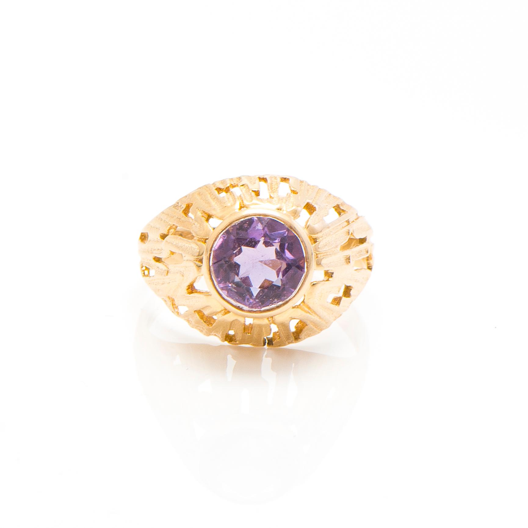 A set of 14K gold earrings and a ring with amethysts.