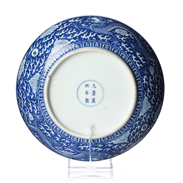 A rare large blue and white 'five clawed dragon' dish, Qing dynasty with Kangxi mark and of the preriod (1662-1722).