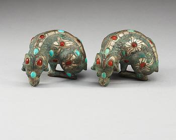 A pair of archaistic bronze figures of rams.