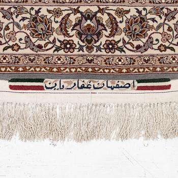 A semi-antique Isfahan rug, central Persia, signed Ghaffarian, c. 180 x 112 cm.