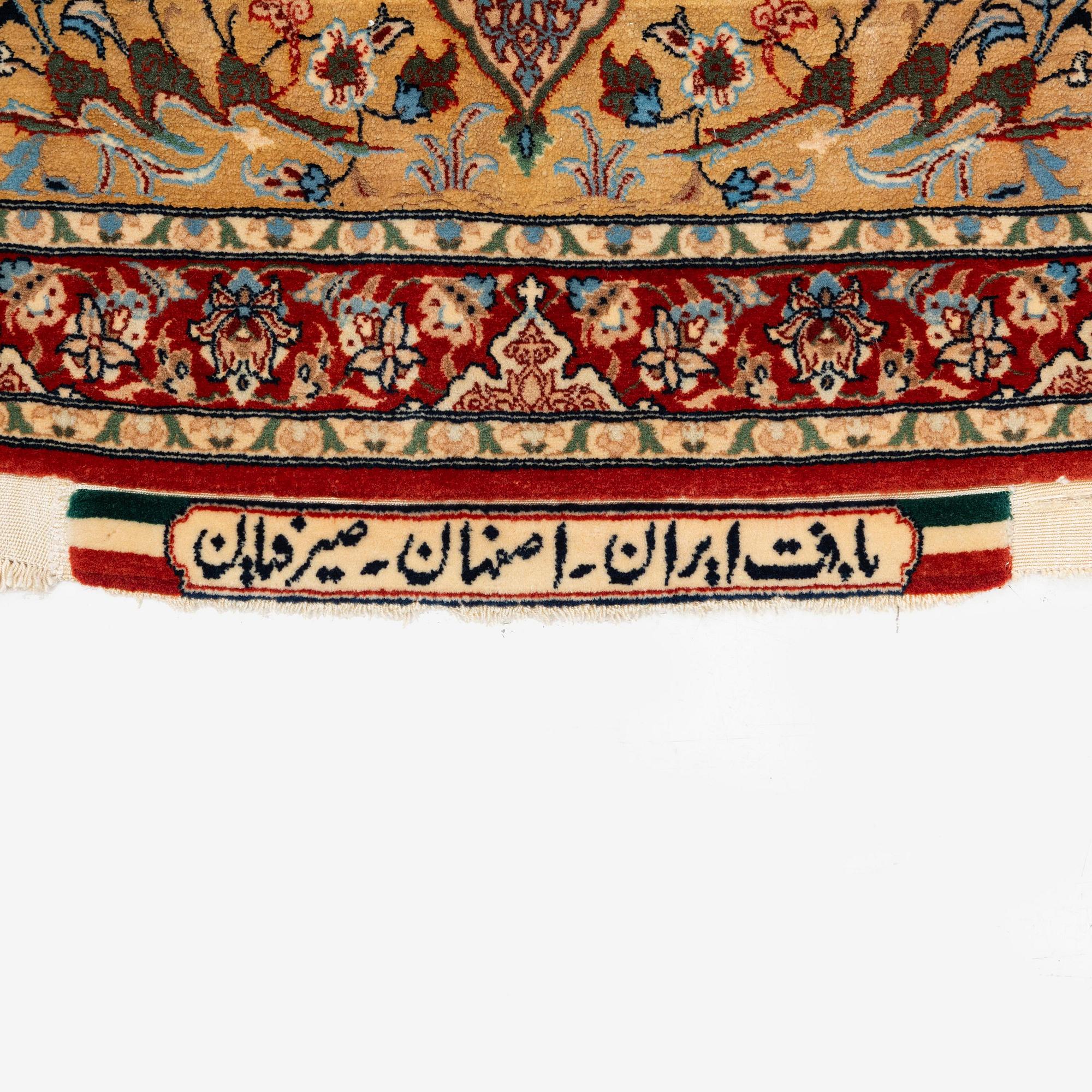 A semi-antique Isfahan rug, central Iran, part silk, signed (Mohammed) Seirafian, c. 120 x 70 cm.