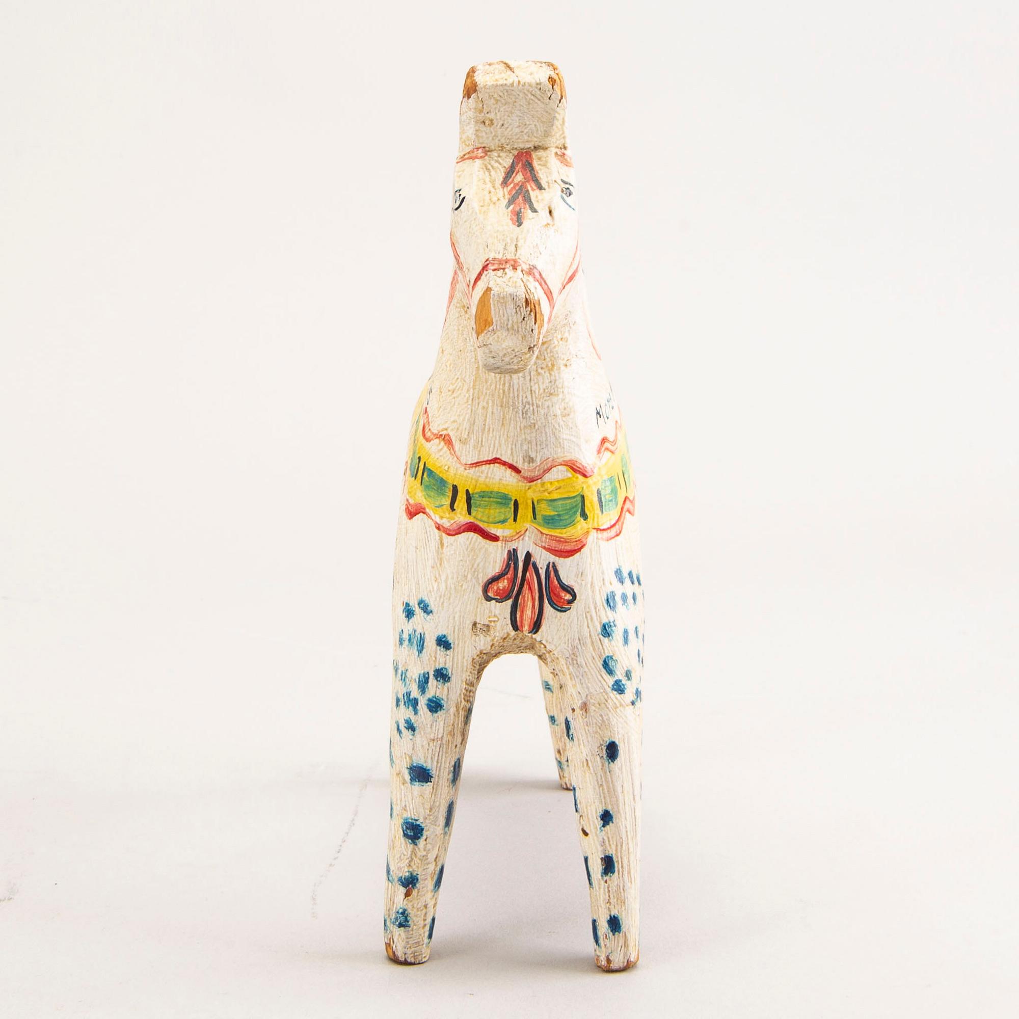 A Swedish painted and dated 1945 wooden horse.