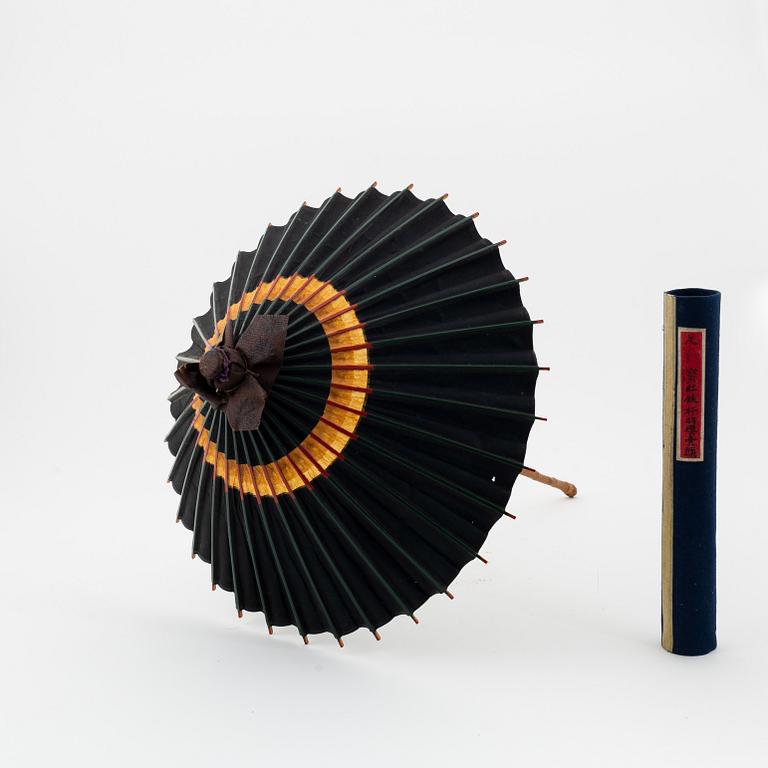 A set of six fans and two umbrellas and a wig/pony tail. Japan, early 20th Century.