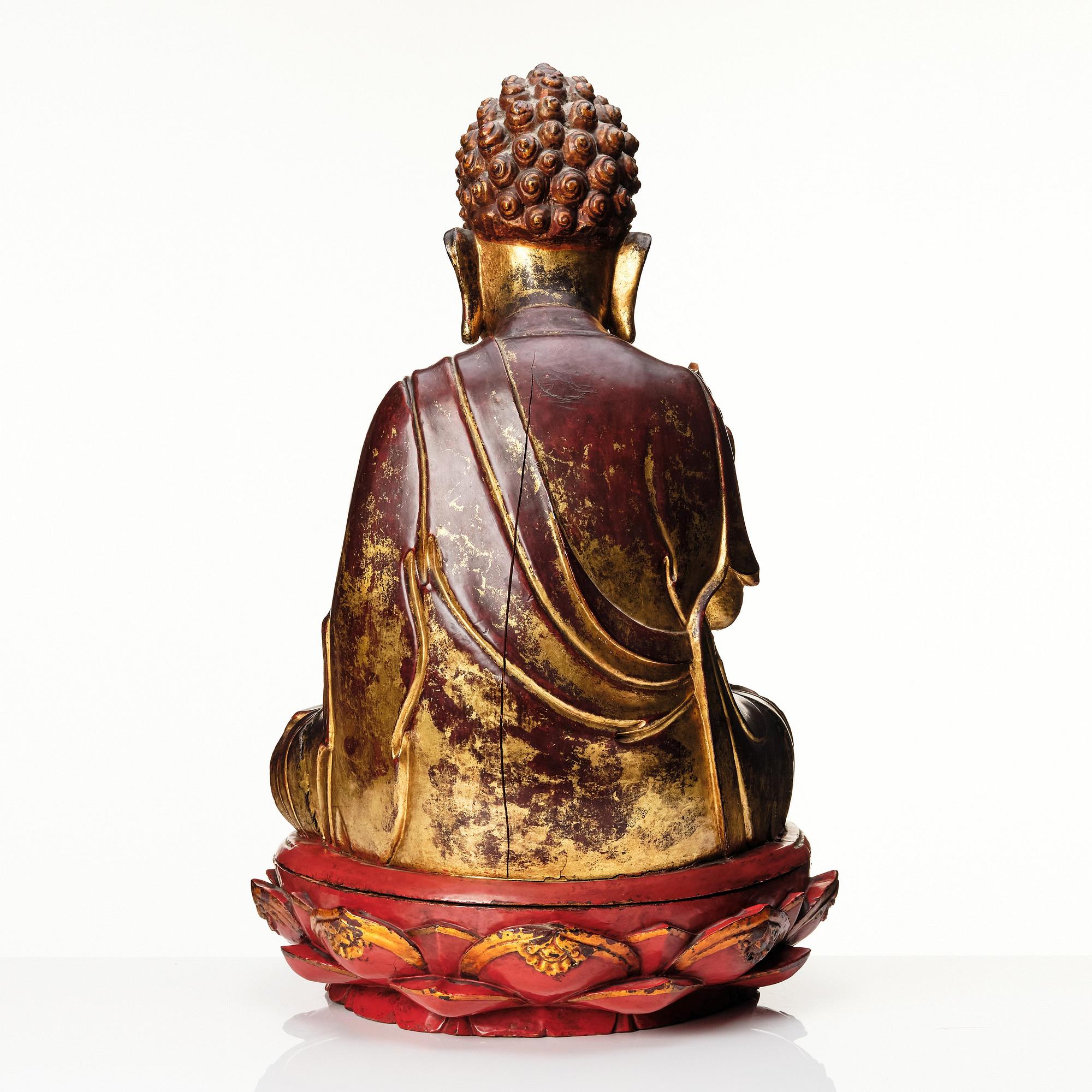 A large gilt and lacquered figure of a seated buddha, Qing dynasty, 19th Century.