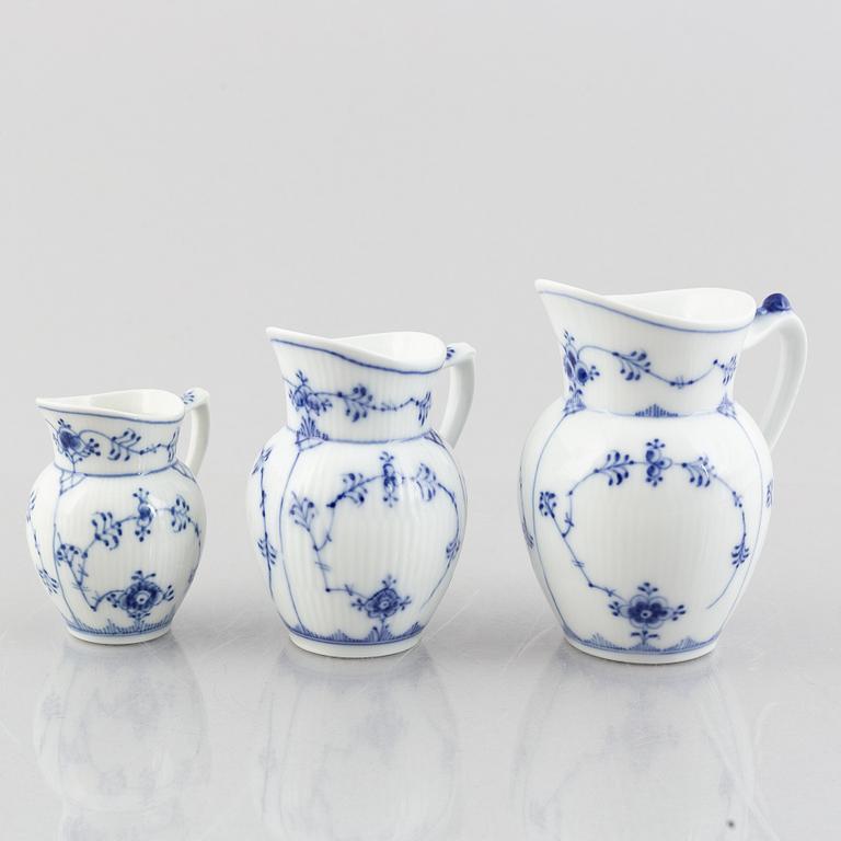 Three 'Blue Fluted Plain' / 'Musselmalet' porcelain jugs, Royal Copenhagen, 20th century.