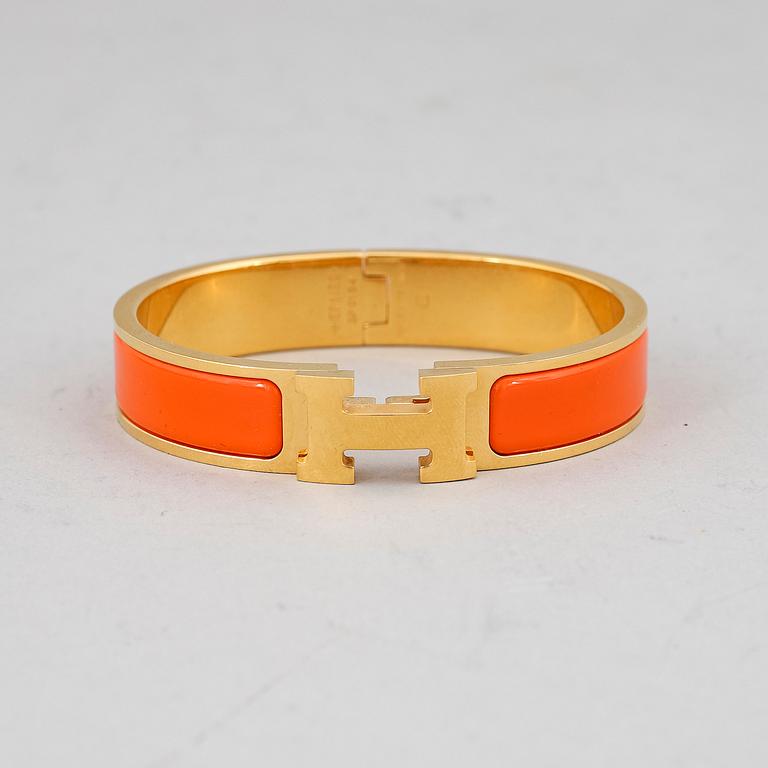 HERMÈS, a 'Clic H' bangle.