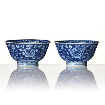 A pair of blue and white reverse decorated floral bowls, Qing dynasty, Kangxi (1662-1722).
