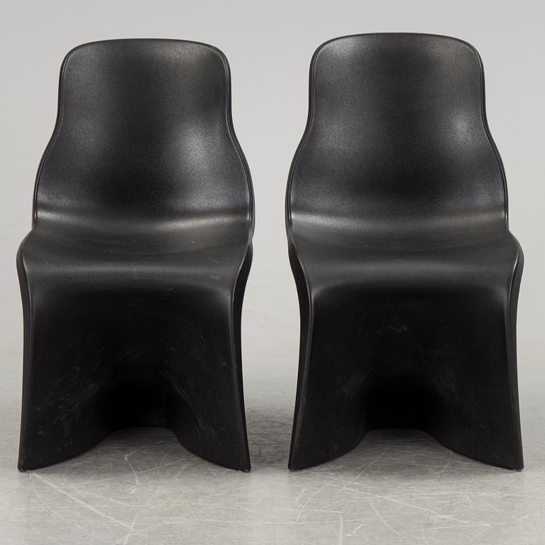 a pair of Italian black plastic chairs designed by Fabio Novembre "Him" and "Her" from the late 20th Century.