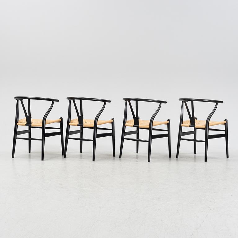 Hans J Wegner, a set of four 'Wishbone chairs' by for Carl Hansen & Son, Denmark.