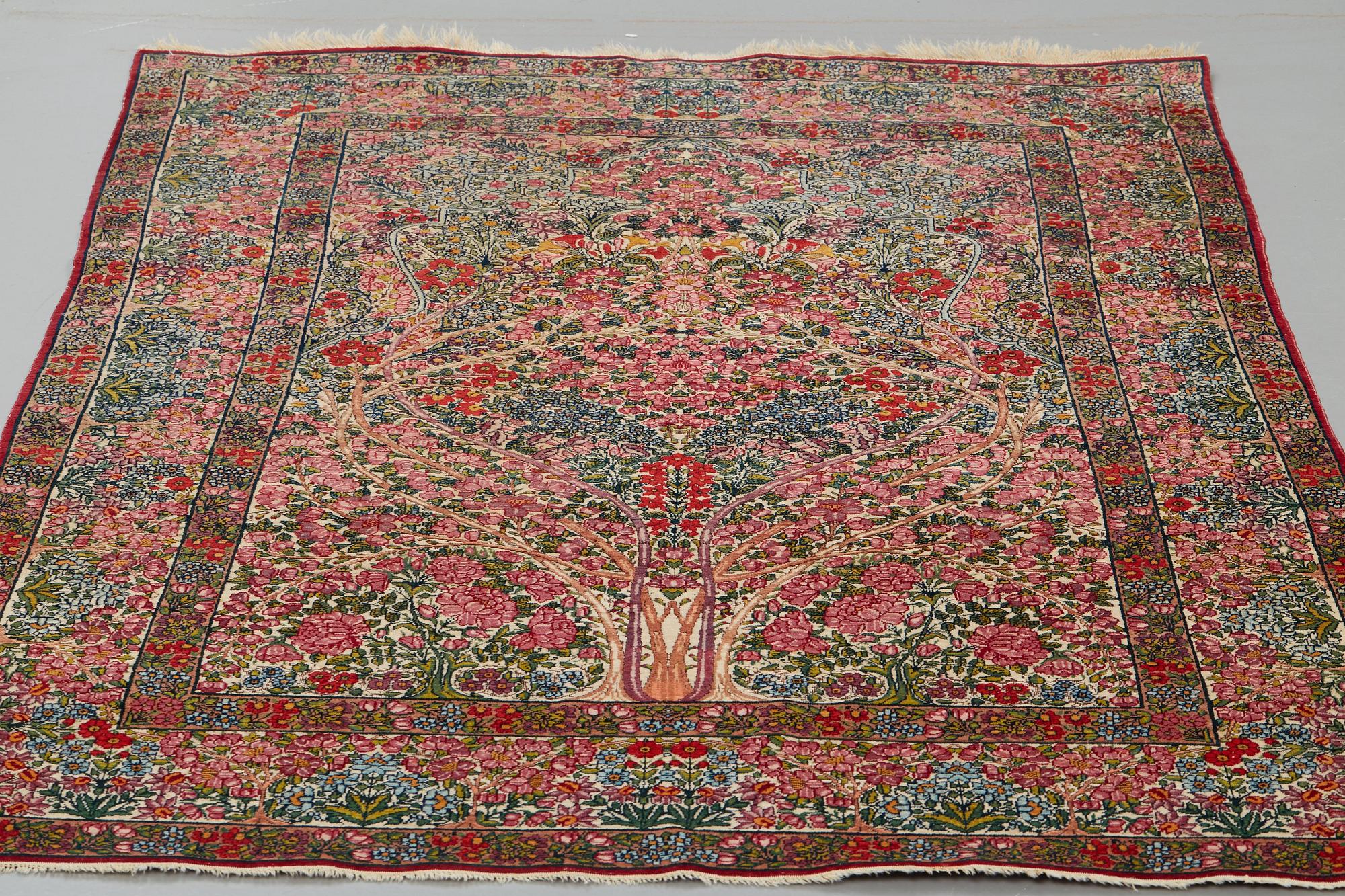 A RUG, a semi-antique Kerman "mille-fleur", ca 198,5 x 136,5 cm.
