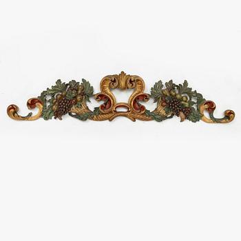 A carved and painted Baroque style wall decoration, 20th Century.