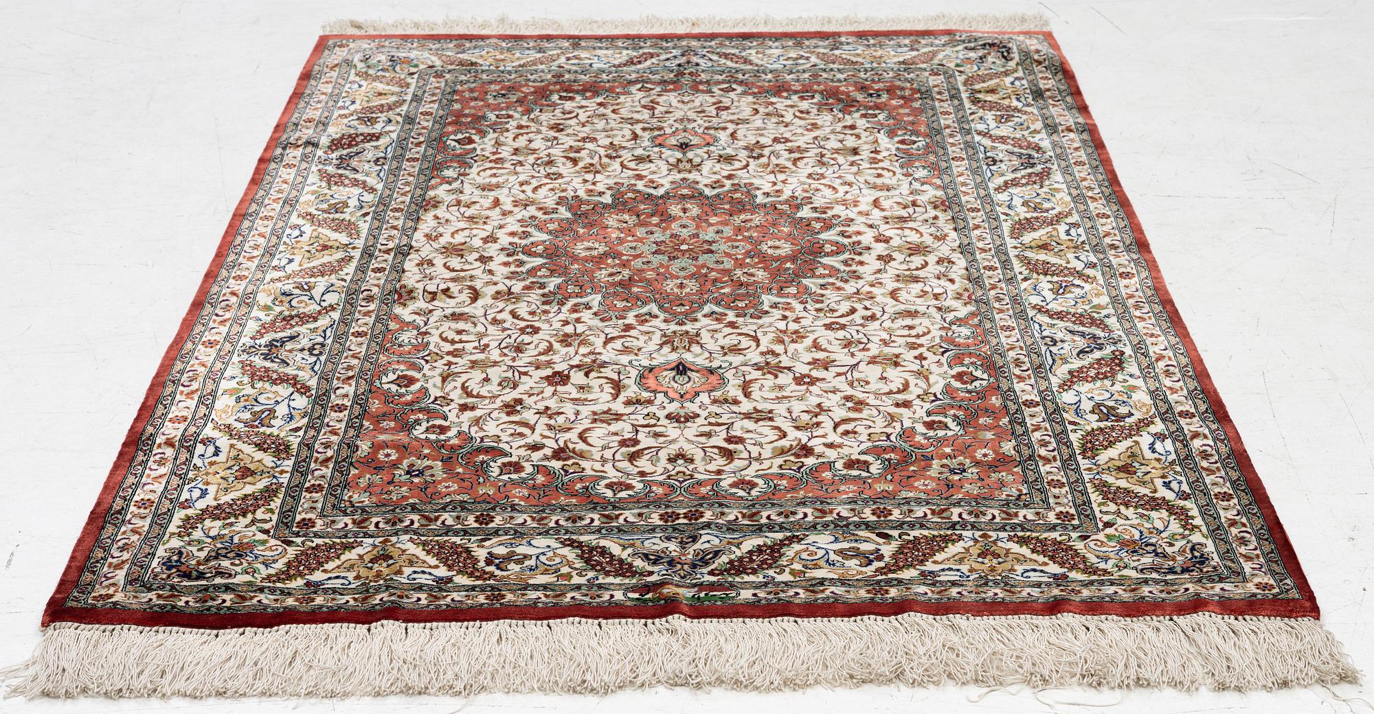 A Ghom silk rug, signed, c. 148 x 100 cm.