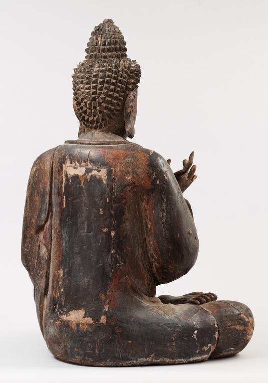 A Japanese partly lacquered wooden seated figure of Buddha, Edo (1603-1868).