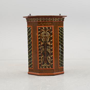 A folk art corner cabinet.