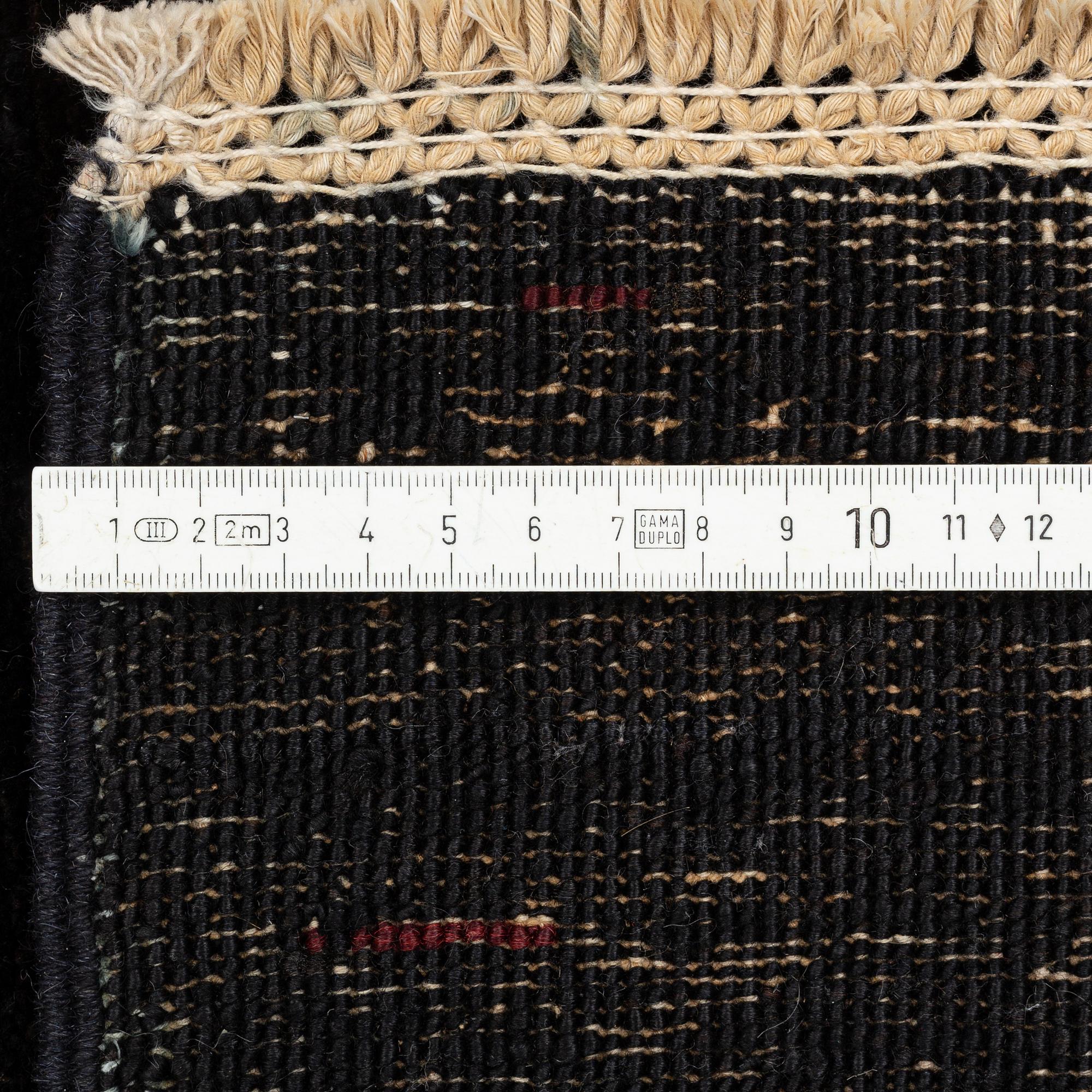 A figural oriental Carpet, circa 263 x 201 cm.