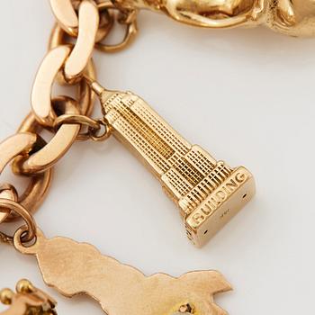 An 18K gold charm bracelet.