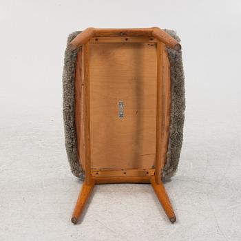 An sheepskin upholstered oak stool, mid 20th Century.