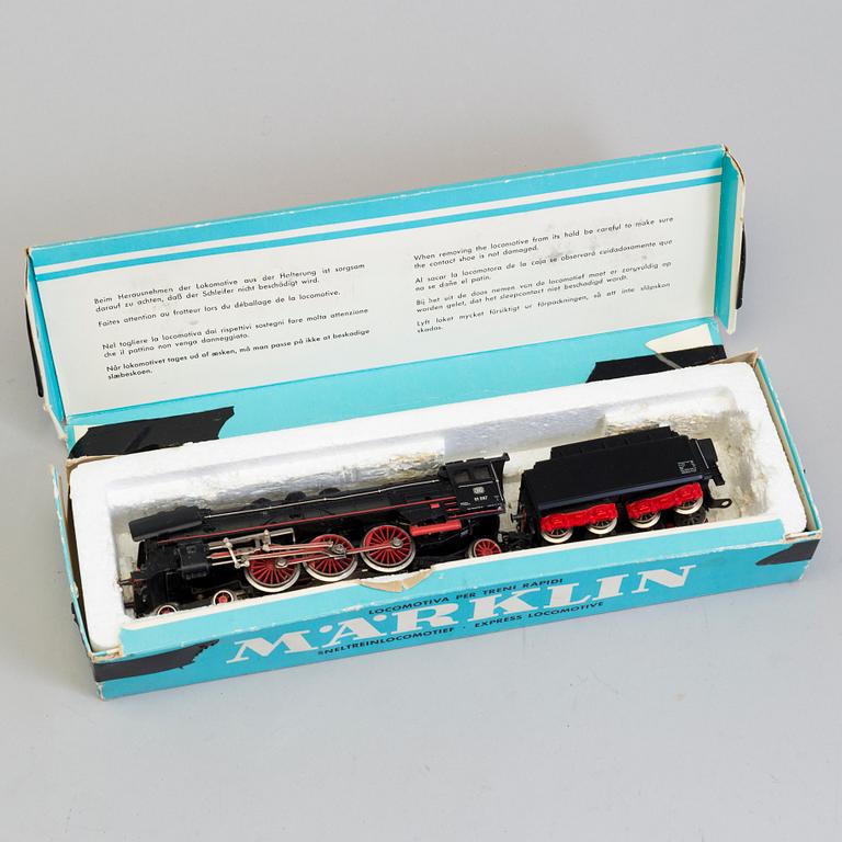 A set of Märklin electric trains, wagons,  rails, and a bridge.