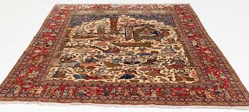 A signed semi-antique pictoral part silk Qum carpet, c. 341 x 224 cm.