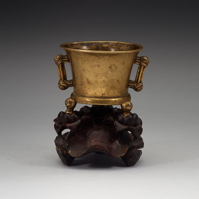 A gilt copper alloy tripod censer, Qing dynasty, presumably 18th Century with Xuandes six character mark.