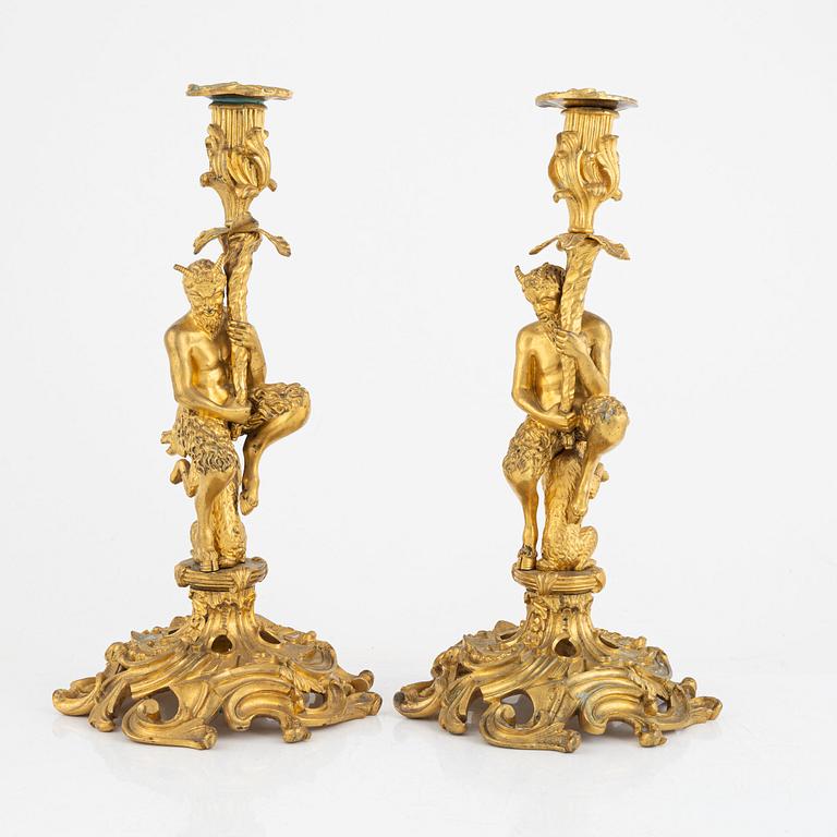 A pair of French gilt-bronze Louis XV-style candlesticks, late 19th century.