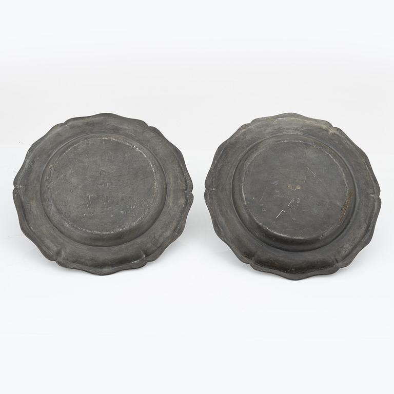 A pair of rococo pewter chargers, mid 18th Century.