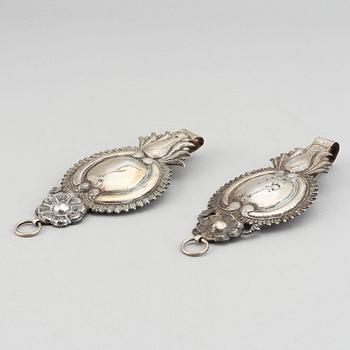 A pair of 19th century silver curtain tie-backs.