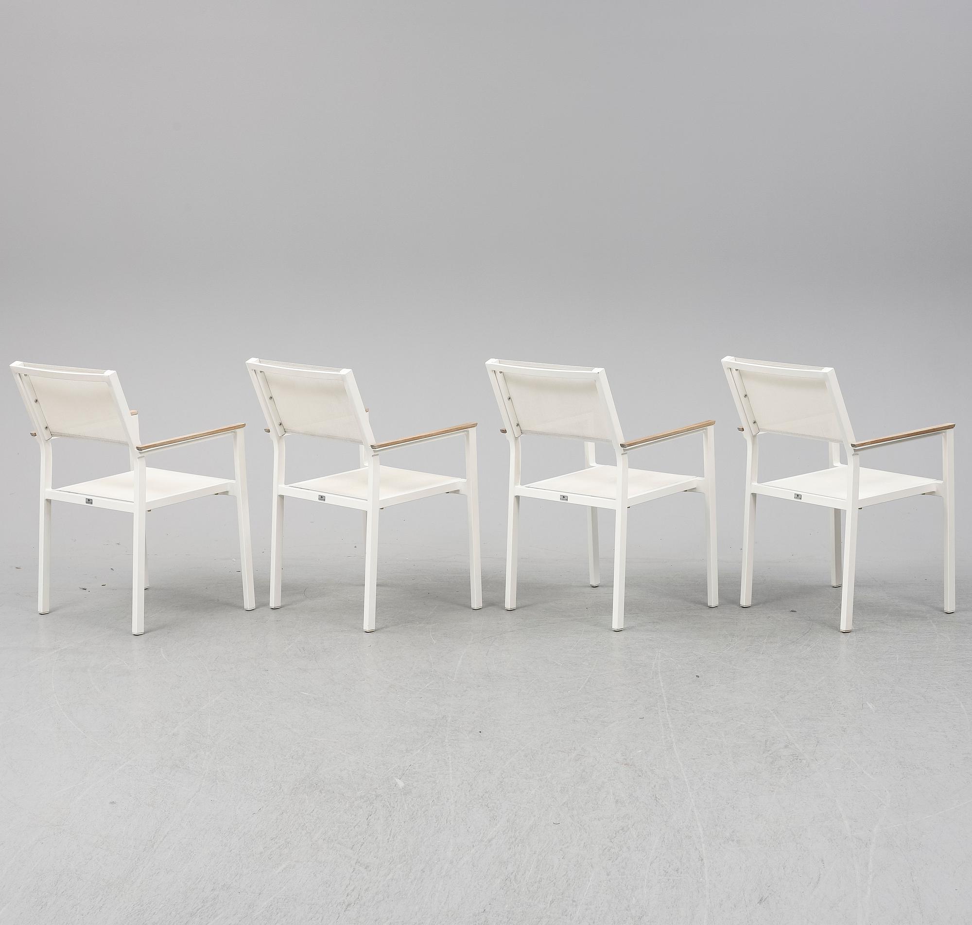 A garden table with four chairs, Gloster.
