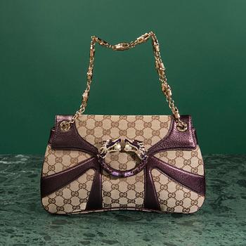 A bag VÄSKA, by Gucci.