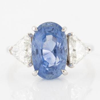 Ring with sapphire and triangle-cut diamonds.