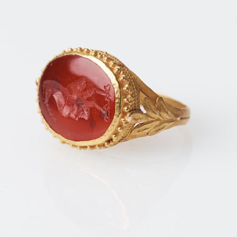 A possibly Etruscan gold and carnelian signet ring.