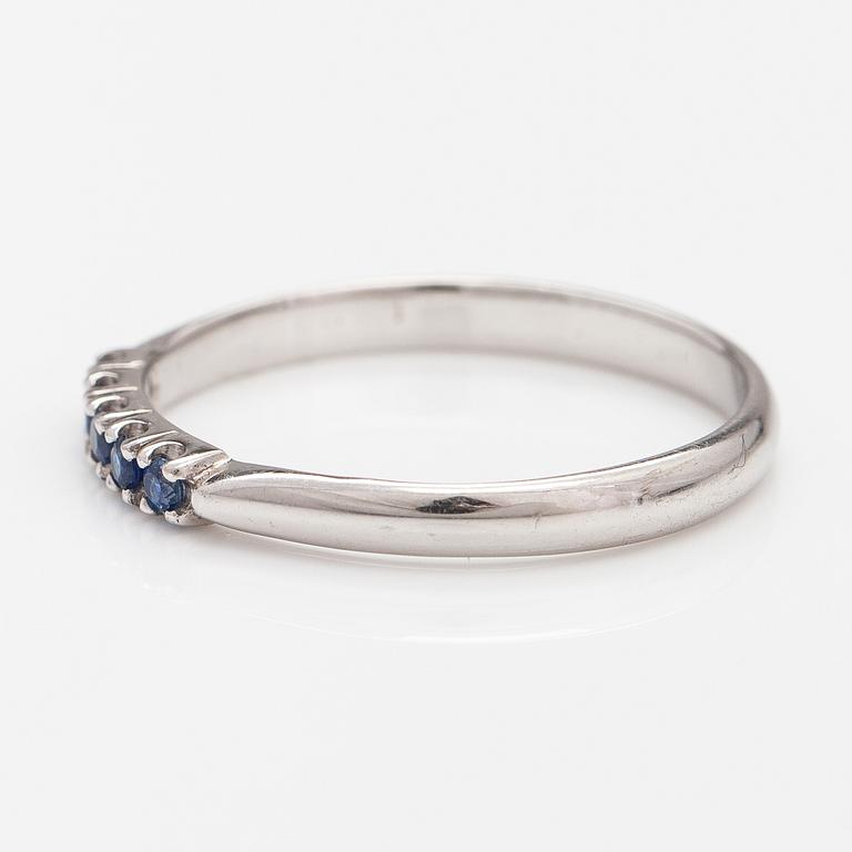 A 14K white gold ring with sapphires.