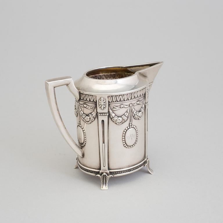 A set of three silver objects (coffeepot, creamer and sugarbowl, CG Hallberg and GAB, Stockholm 1907. Weight ca 1226 gr.
