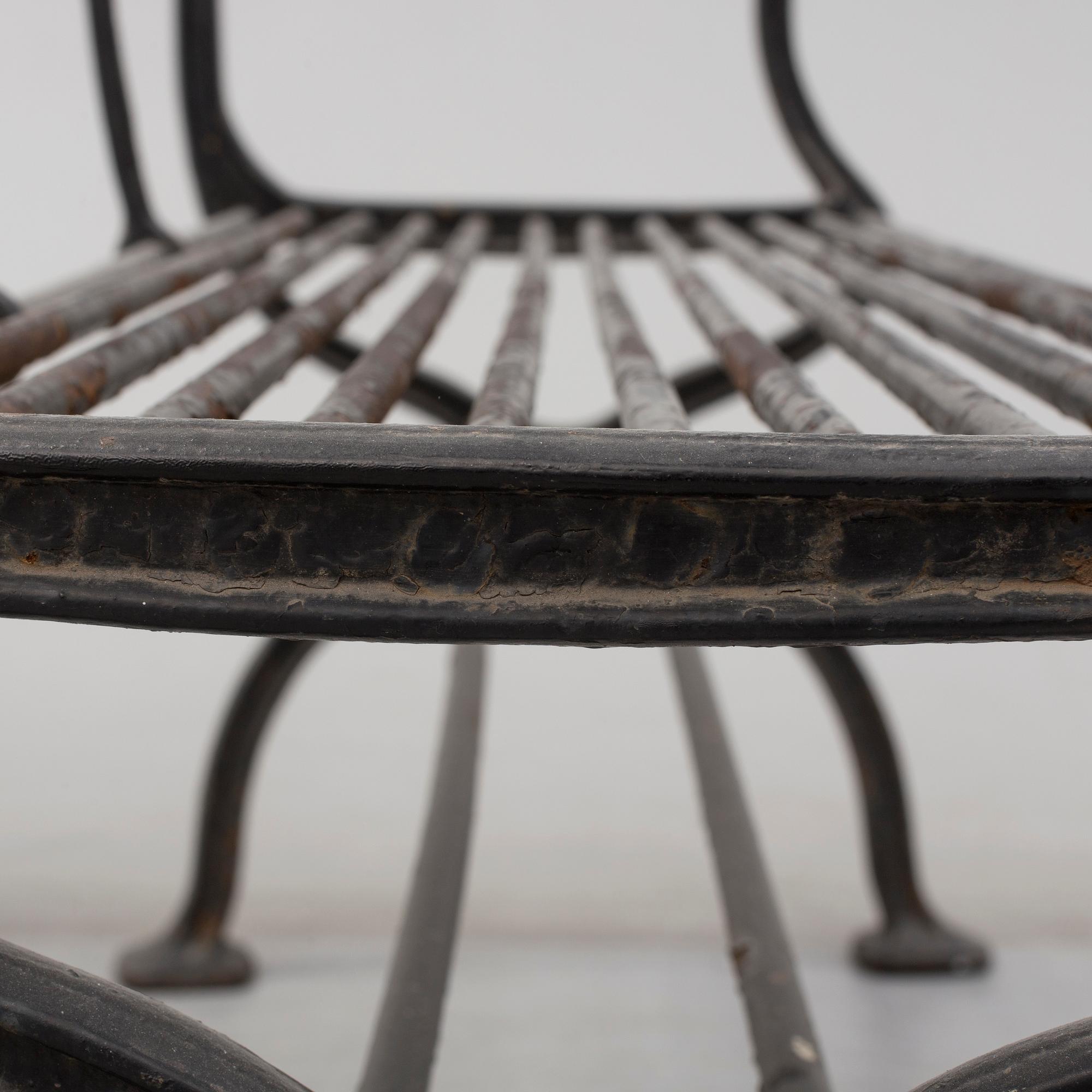 GARDEN SOFAS, a pair, cast iron, empire style, late 19th century.