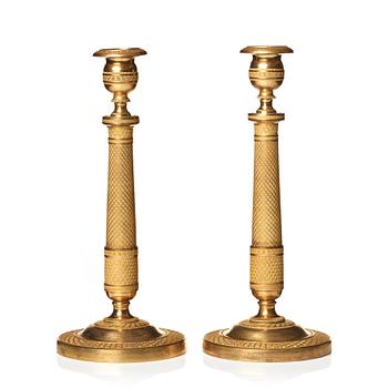 122. A pair of Empire candlesticks.