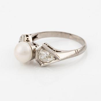 A ring with a bouton pearl and two old-cut diamonds.