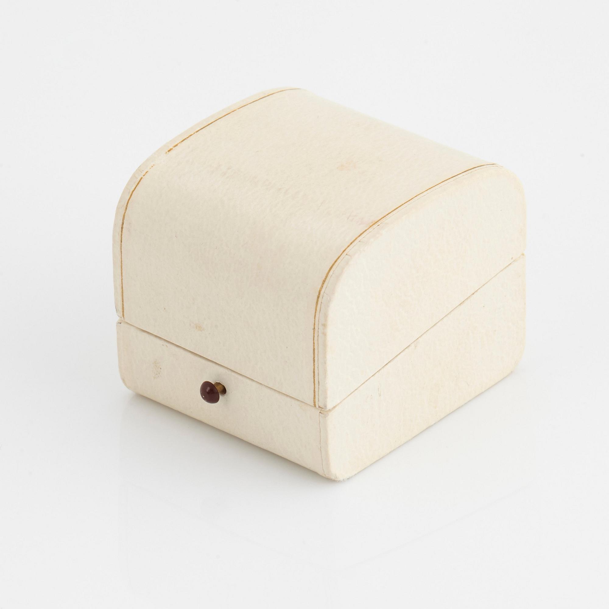 A Sigurd Persson 18K gold ring set with a faceted garnet.