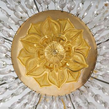 An French Empire eight-light gilt-brass and cut-glass chandelier.