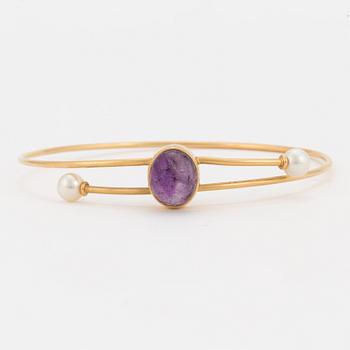 A bangle set with a cabochon-cut amethyst and cultured pearls.