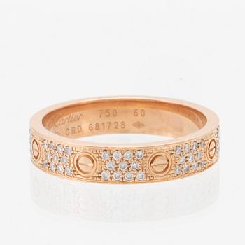 A Cartier "Love" ring in 18K rose gold with pavé-set round brilliant-cut diamonds.