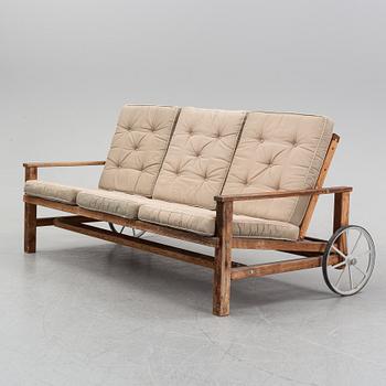 A stained pine garden sofa by Elsa Stackelberg.