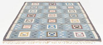 Edna Martin, a carpet, 'Flickorna i fönstret', flat weave, c 295 x 202 cm, signed SH.