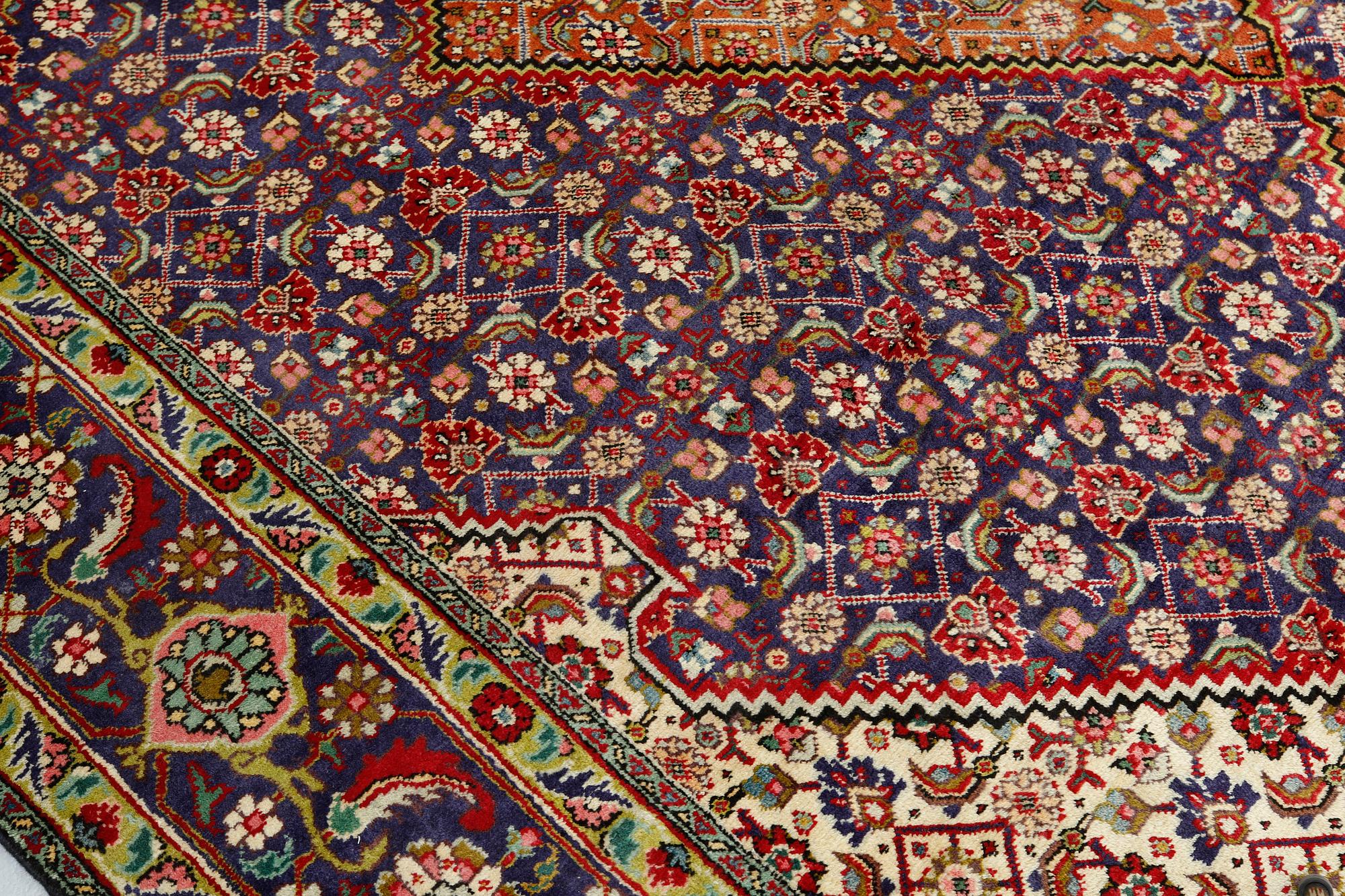 A Tabriz carpet, approximately 360 x 255 cm.